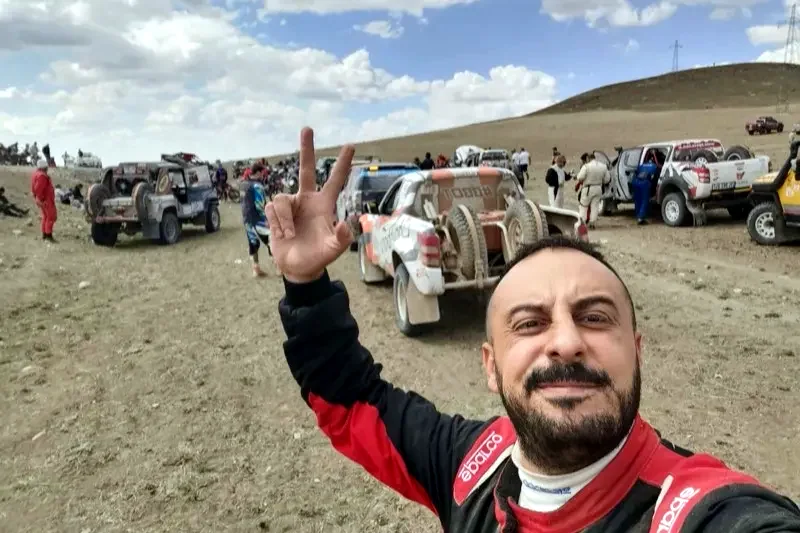 Atilla Baybara in race suit taking a selfie at the rally service park